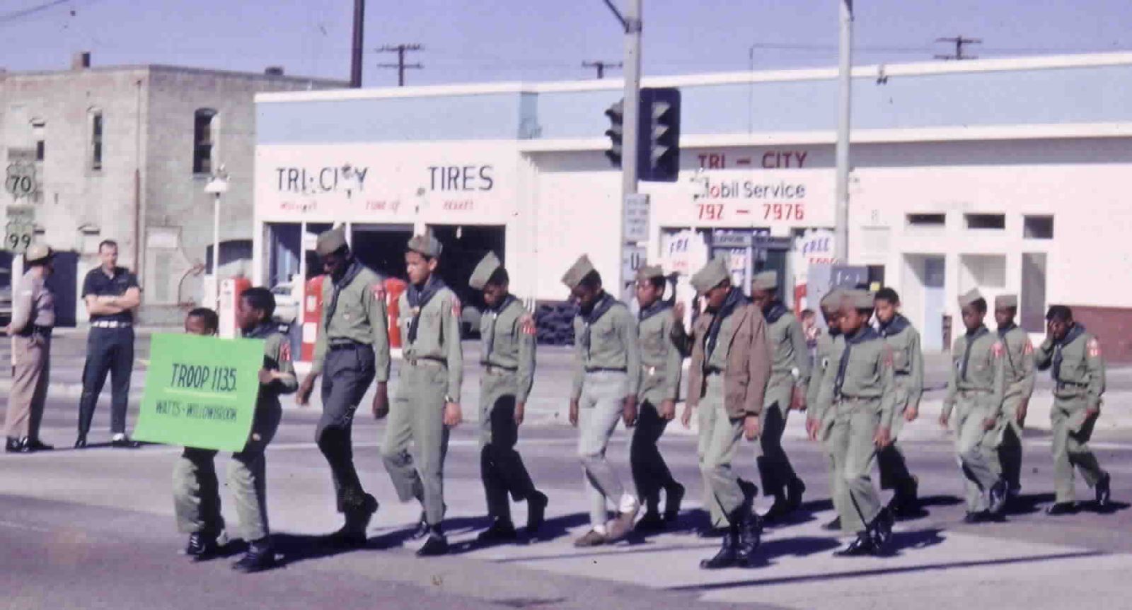 Troop 1135 marching behind a sign reading Troop 1135