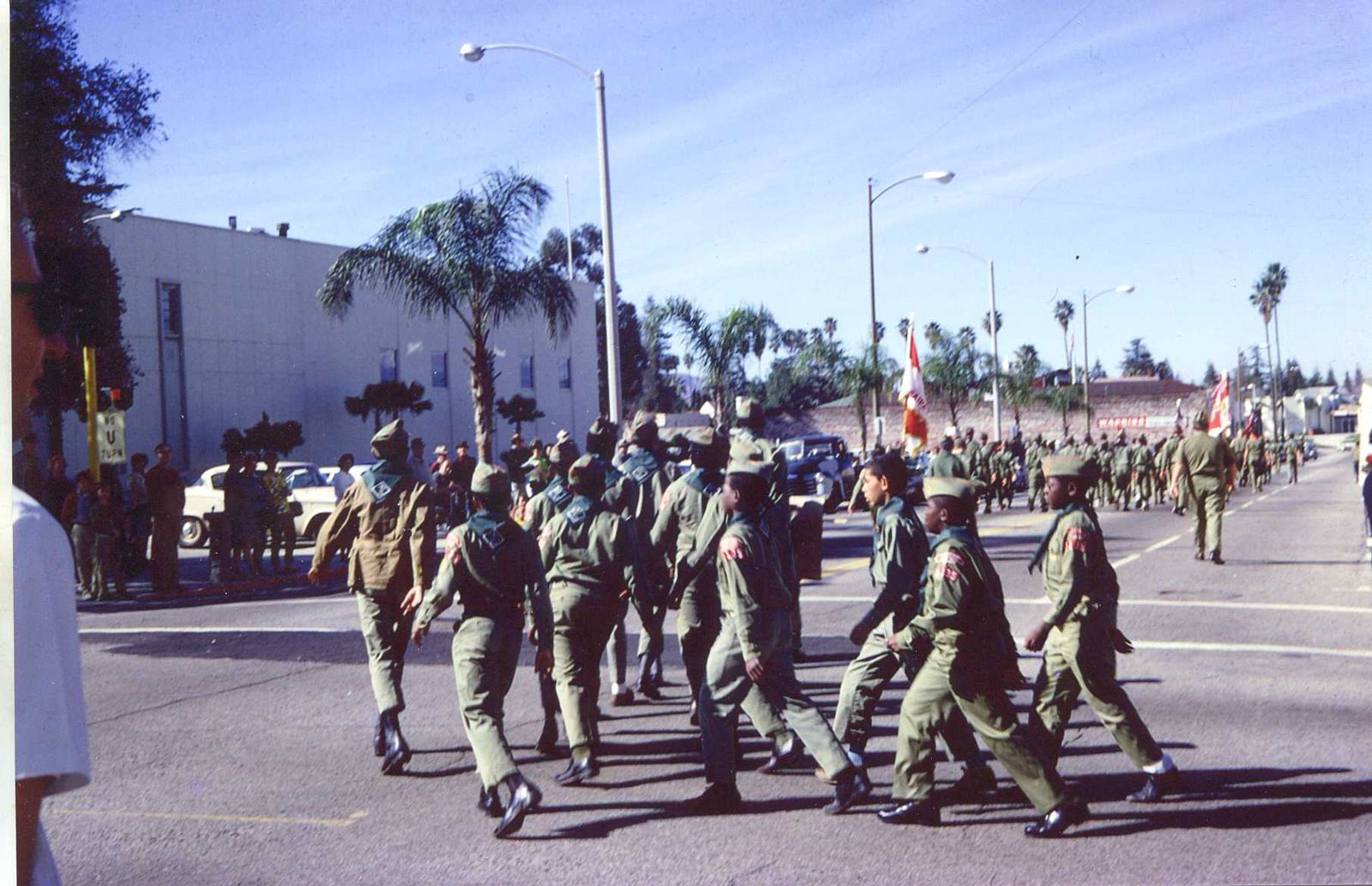 Troop 1135 marching in uniform down a Redlands street